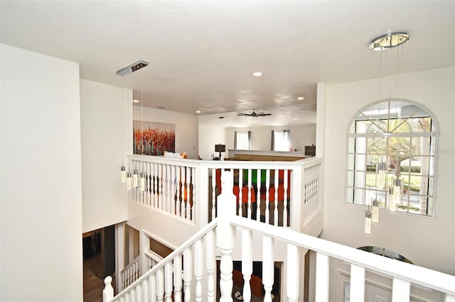 hallway featuring recessed lighting and an upstairs landing