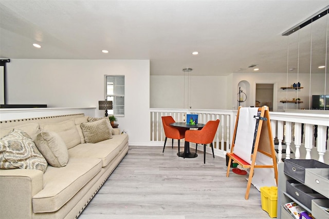 living room with light wood-style floors and recessed lighting