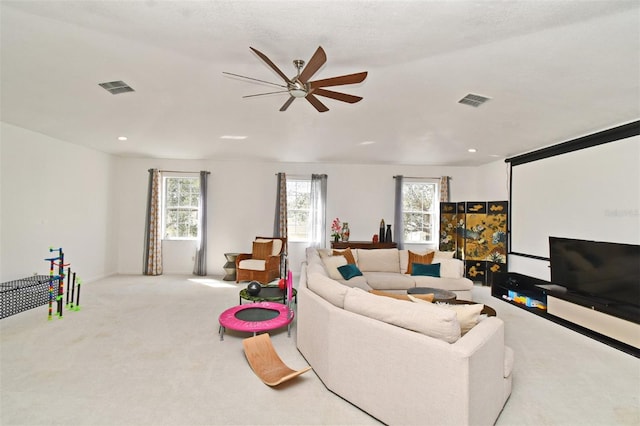 living room with light carpet, visible vents, and a wealth of natural light