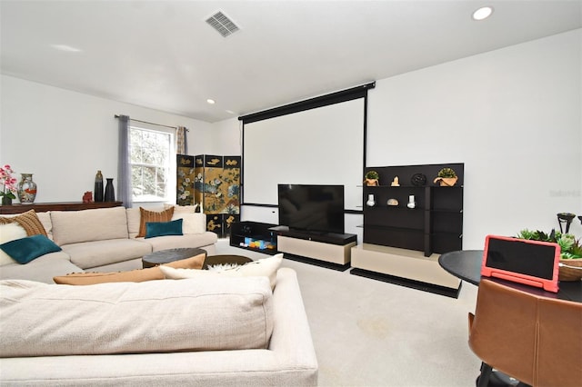 living area featuring recessed lighting, visible vents, and light carpet