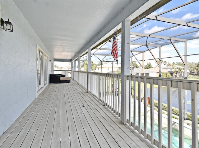 wooden terrace featuring a water view