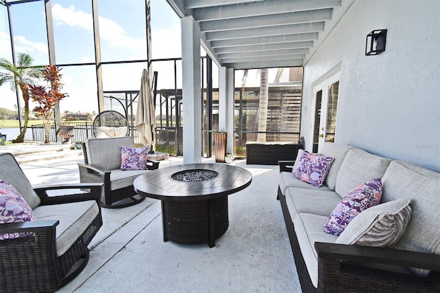 view of patio with an outdoor living space with a fire pit