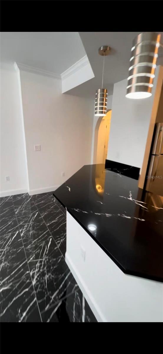 interior details featuring baseboards and ornamental molding