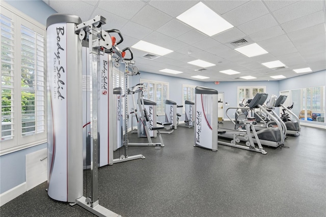 gym featuring a paneled ceiling, plenty of natural light, and visible vents