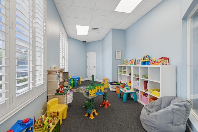 playroom featuring a drop ceiling, visible vents, and baseboards