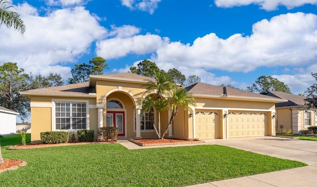 view of front of house featuring a garage, concrete driveway, french doors, a front lawn, and stucco siding