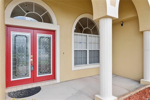 doorway to property with french doors and stucco siding