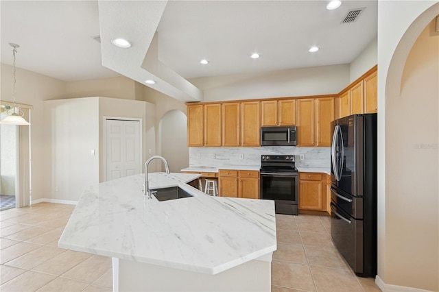 kitchen with light tile patterned floors, visible vents, decorative backsplash, stainless steel appliances, and a sink