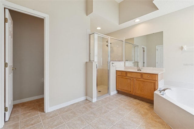 full bathroom featuring a stall shower, baseboards, tile patterned floors, a garden tub, and vanity