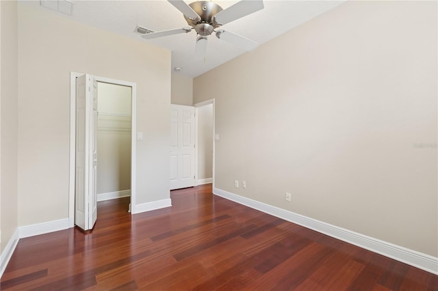 unfurnished bedroom featuring a closet, visible vents, baseboards, and wood finished floors