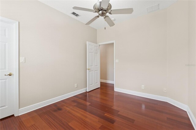 unfurnished room with visible vents, ceiling fan, baseboards, and wood finished floors