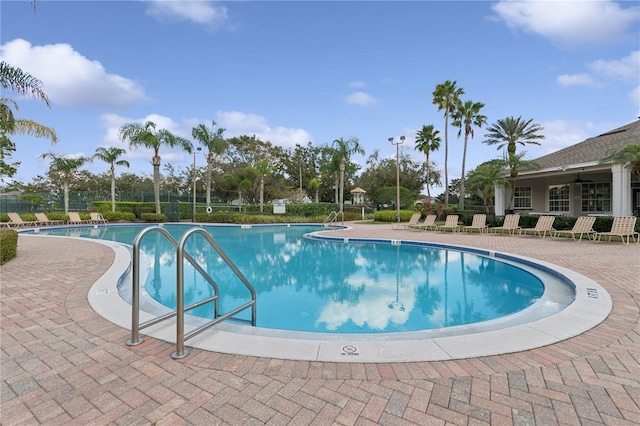 pool featuring a patio area and fence