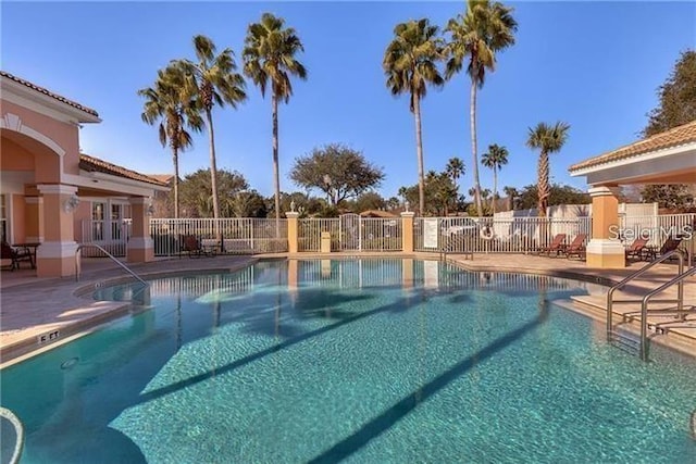 pool featuring a patio and fence