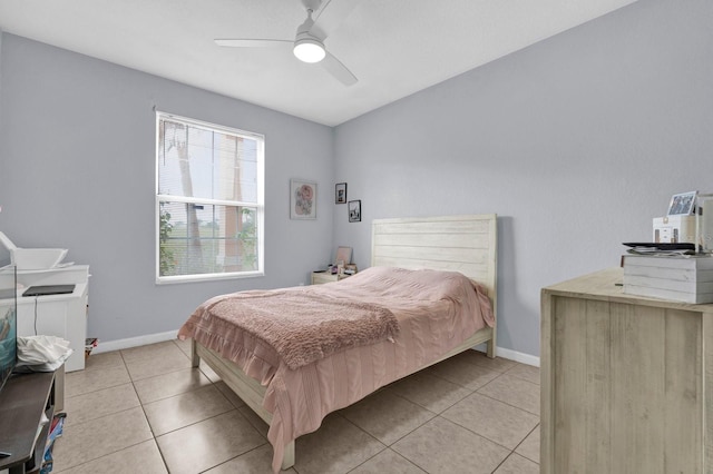 bedroom featuring light tile patterned floors, a ceiling fan, and baseboards