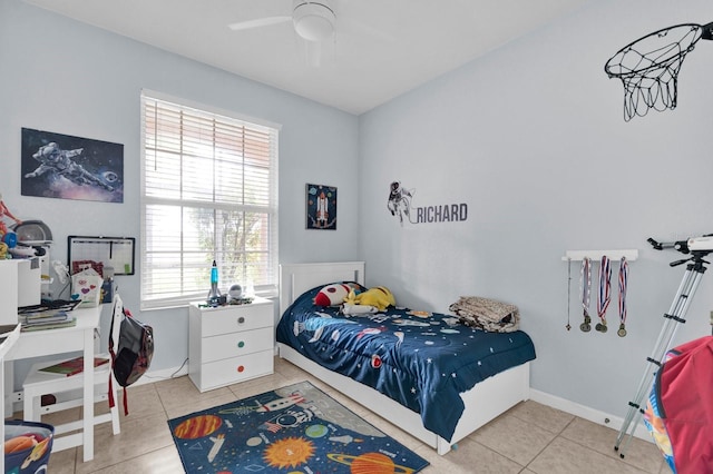 tiled bedroom with a ceiling fan and baseboards