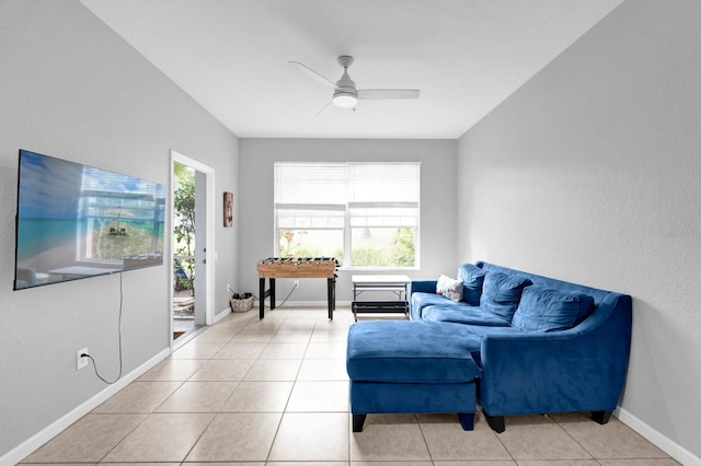 tiled living room with ceiling fan, baseboards, and a wealth of natural light