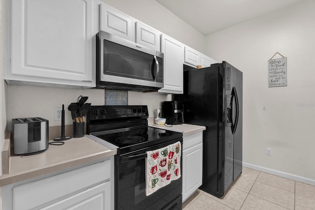 kitchen with light tile patterned floors, black appliances, light countertops, and white cabinets