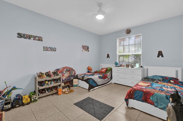 bedroom with ceiling fan and light tile patterned flooring