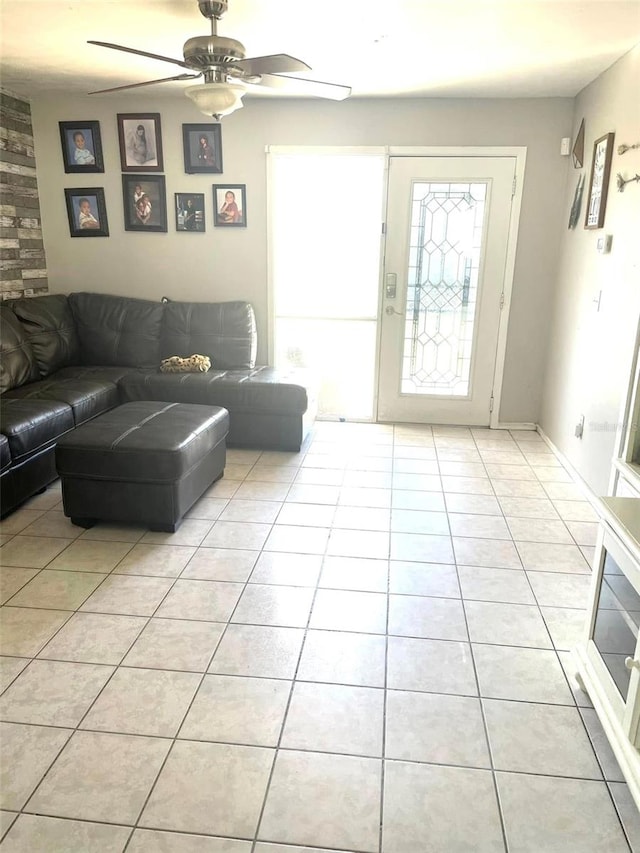 living room featuring light tile patterned floors and a ceiling fan