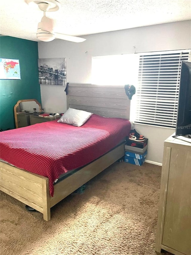 bedroom featuring baseboards, a textured ceiling, and carpet flooring