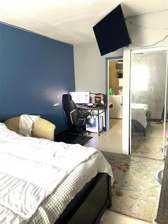 tiled bedroom featuring washer / clothes dryer