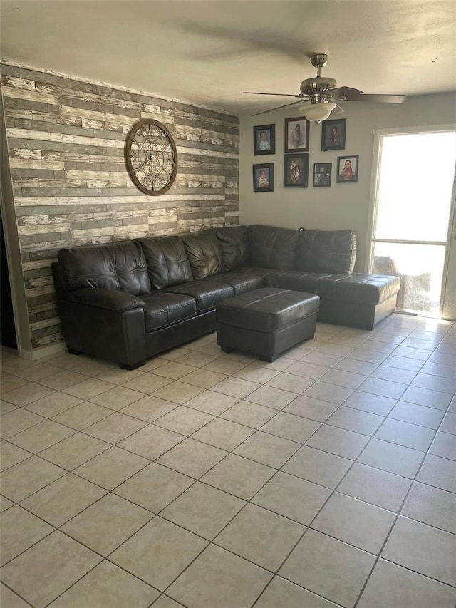 living area featuring light tile patterned floors and ceiling fan