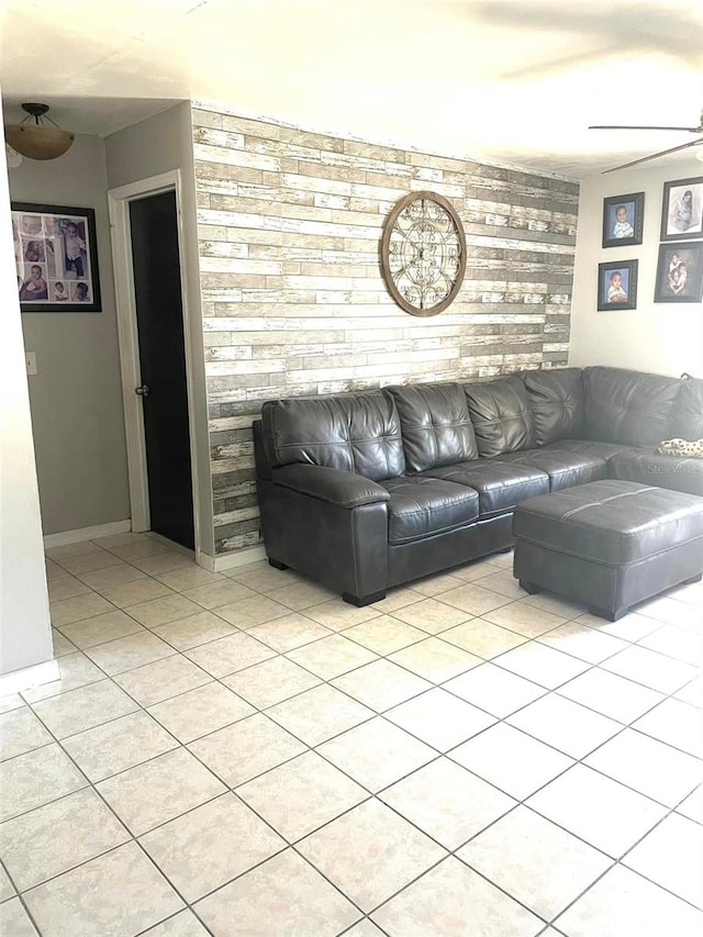 unfurnished living room with light tile patterned flooring and baseboards