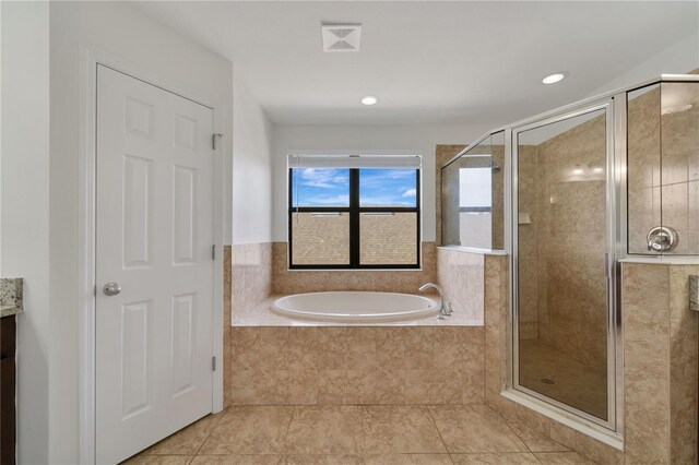 7108 Harvest Glen Ln, Riverview, FL 33578 - bathroom with a bath, a stall shower, tile patterned flooring, vanity, and recessed lighting