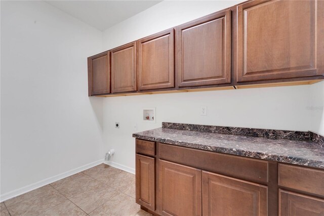 7108 Harvest Glen Ln, Riverview, FL 33578 - washroom with electric dryer hookup, cabinet space, hookup for a washing machine, baseboards, and light tile patterned floors