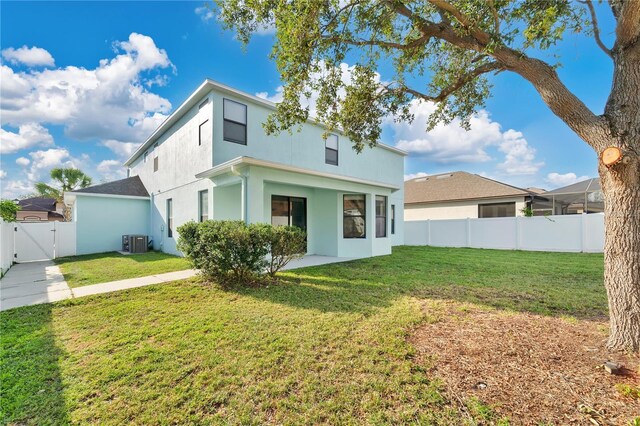 7108 Harvest Glen Ln, Riverview, FL 33578 - rear view of house with a gate, stucco siding, and central AC
