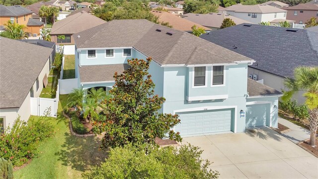 7108 Harvest Glen Ln, Riverview, FL 33578 - view of front facade featuring a residential view, roof with shingles, stucco siding, and concrete driveway