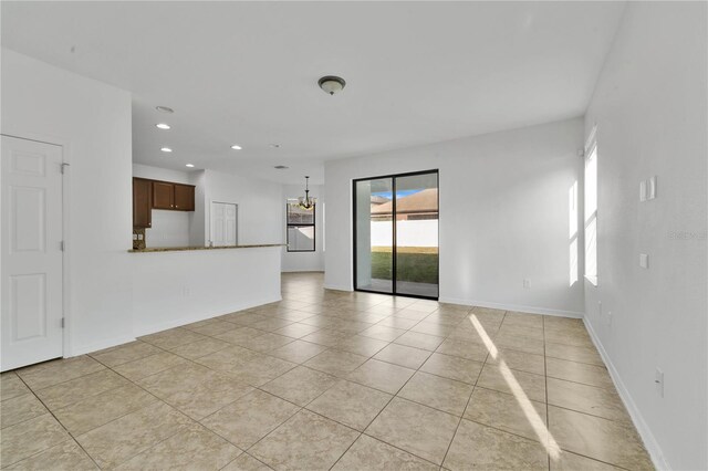 7108 Harvest Glen Ln, Riverview, FL 33578 - unfurnished living room with light tile patterned floors, recessed lighting, and baseboards