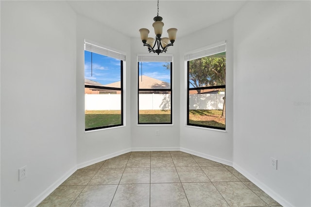 7108 Harvest Glen Ln, Riverview, FL 33578 - empty room featuring a chandelier, light tile patterned flooring, and baseboards