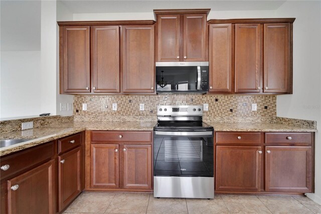 7108 Harvest Glen Ln, Riverview, FL 33578 - kitchen featuring stainless steel appliances, light stone countertops, and decorative backsplash