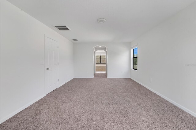 7108 Harvest Glen Ln, Riverview, FL 33578 - carpeted empty room featuring arched walkways and baseboards