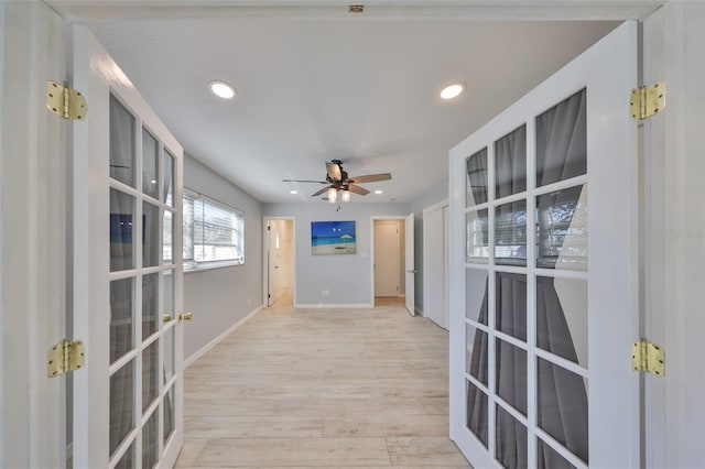 interior space with baseboards, french doors, light wood-style flooring, and recessed lighting