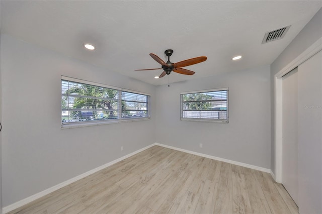 unfurnished room with baseboards, visible vents, ceiling fan, light wood-type flooring, and recessed lighting