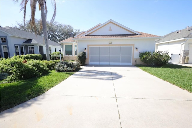 ranch-style house with a front lawn, concrete driveway, an attached garage, and stucco siding