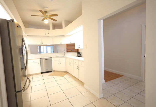 kitchen featuring a sink, light tile patterned floors, stainless steel appliances, and light countertops