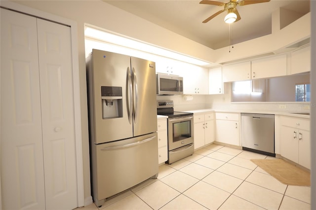 kitchen featuring stainless steel appliances, light countertops, a ceiling fan, white cabinetry, and light tile patterned flooring