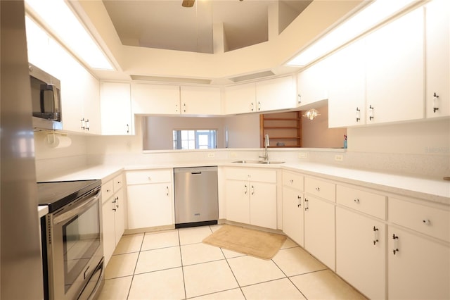 kitchen with stainless steel appliances, light countertops, a sink, and light tile patterned floors