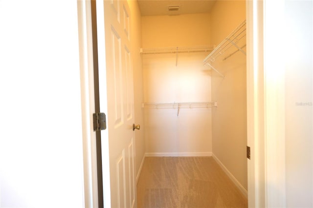 walk in closet with carpet flooring and visible vents