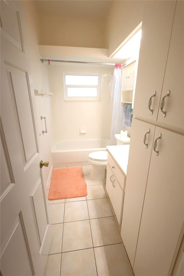 bathroom featuring shower / bath combo with shower curtain, vanity, toilet, and tile patterned floors