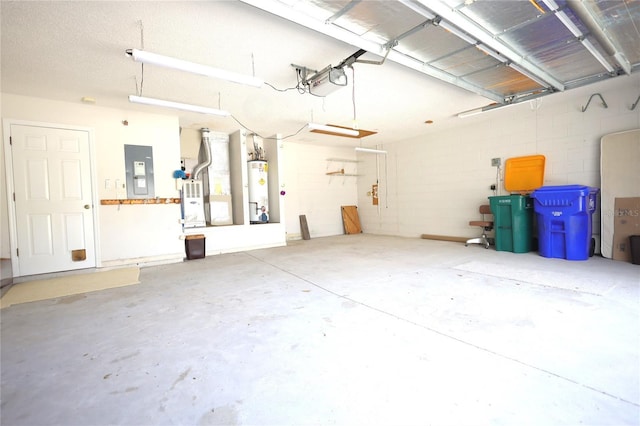 garage featuring a garage door opener, concrete block wall, electric panel, and water heater