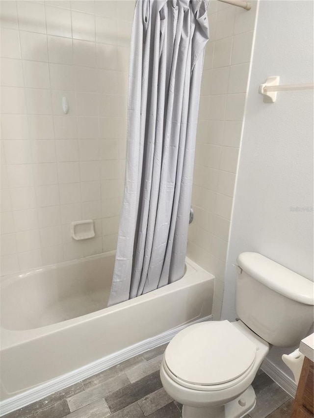 full bathroom with toilet, shower / bath combo with shower curtain, wood finished floors, and vanity