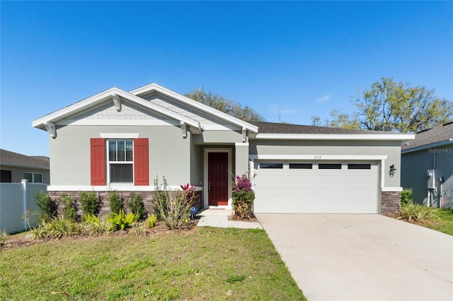 craftsman-style house with stucco siding, concrete driveway, a front yard, a garage, and stone siding