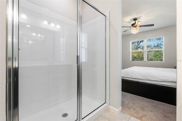 bathroom with ensuite bathroom, a stall shower, tile patterned flooring, and a ceiling fan