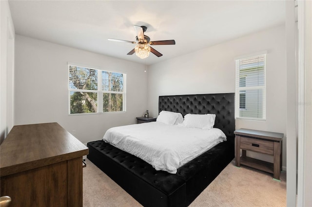 bedroom with light colored carpet and ceiling fan