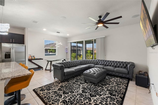 living area with light tile patterned floors, visible vents, and a ceiling fan