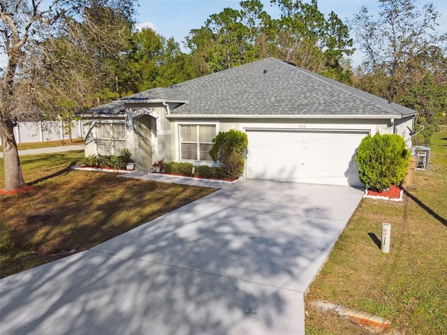 single story home featuring concrete driveway, roof with shingles, an attached garage, a front yard, and stucco siding